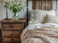 Close up of bedside cabinet near bed with beige bedding.