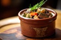 close-up of beef bourguignon in a rustic clay pot