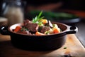 close-up of beef bourguignon in a rustic clay pot