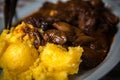 Braised beef with onion and corn polenta Royalty Free Stock Photo