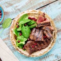 Close up beef steak grilled with spinach leaves and pomegranate Royalty Free Stock Photo