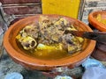 Close up of Beef Tajine, Moroccan slow-cooked stew served and cooked in earthenware pot in Medina of Marrakech, Morocco.