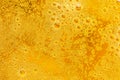 Close up of beer bubbles and foam as a background. Droplets on freshly poured beer texture