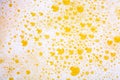 Close up of beer bubbles and foam as a background. Oktoberfest abstract background. Craft lager beer. Festive pint of ale with Royalty Free Stock Photo