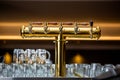 Close up of a beer faucet or tap with huge arrenge of an empty glasses in the bar or pub, restaurant concept Royalty Free Stock Photo