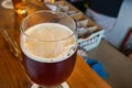 Close-up of beer glass placed on a wooden table in a restaurant Royalty Free Stock Photo