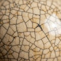 Close-up of a beige ceramic surface displaying a crackle glaze pattern. The glaze Royalty Free Stock Photo