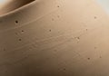 A close-up of a beige ceramic surface, likely part of a pottery piece. The texture Royalty Free Stock Photo