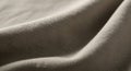 Close-up of a beige fabric with a visible textured weave. The surface is gently draped, creating Royalty Free Stock Photo