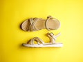 Close up of beige leather summer comfortable women`s sandals on brigth yellow background. Top view, side view, flat lay