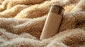 Close Up of a Beige Lighter Resting on a Fluffy Beige Lambswool Blanket Texture Royalty Free Stock Photo