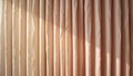 Close up of beige vertical blinds with light and shadow patterns visible Royalty Free Stock Photo