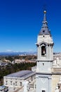 Close-up of the belfry of the Cathedral of Madrid against cityscape