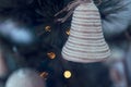 close up of bell hanging from christmas tree with lights on Royalty Free Stock Photo