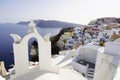 Close-up of bell tower of a church in Oia village with cozy picturesque sight, Santorini, Greece Royalty Free Stock Photo