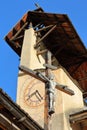 Close-up on the bell tower of Saint Sebastien Church and the Cross of Jesus Christ, Ceillac