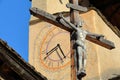 Close-up on the bell tower of Saint Sebastien Church with the Cross of Jesus Christ, Ceillac