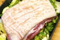 Close up of belly pork on a trivet of veg Royalty Free Stock Photo