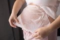 close-up belly of a pregnant woman applying a mask with cream from the appearance of stretch marks, pregnancy, body skin Royalty Free Stock Photo