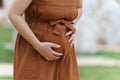 Close up belly of pregnant woman has a stomachache in the park Royalty Free Stock Photo