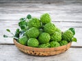 Close up bergamot on wooden table background, also for hair shampoo or conditioner treatment. Kaffir lime