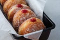 Traditional German Polish Donut with Raspberry Jam Dusted with Sugar. The traditional meal on Fat Thursday, the last day Royalty Free Stock Photo