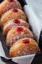 Traditional German Polish Donut with Raspberry Jam Dusted with Sugar. The traditional meal on Fat Thursday, the last day Royalty Free Stock Photo