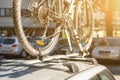 Close-up bicycle on car roof rack railing at outdoor parking. Vehicle with mounted bike on rooftop. Active sport touristic trip co Royalty Free Stock Photo