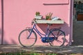 Close-up of bicycle leaning against colorful wall on a sunny day in Burano. Royalty Free Stock Photo