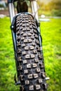 Close up of bicycle tire on green grass background Royalty Free Stock Photo