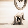 Close-up of bicycle wheels doing trick by rail