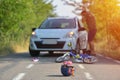 Close-up of a bicycling helmet fallen on the asphalt next to a b