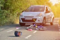 Close-up of a bicycling helmet fallen on the asphalt next to a b