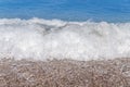 Close up Big blue sea water wave on sand beach with bubbles Royalty Free Stock Photo