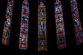 Close-up of big colorful stained glass inside Catholic cathedral windows.