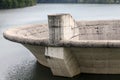 Close-up of a big concrete overflow funnel above the lake.