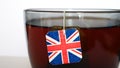 Close-up of a big cup of tea brewing using a tea bag with a United Kingdom flag tag Royalty Free Stock Photo