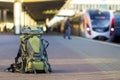 Close-up of big green tourist backpack on railway station platform on blurred background. Traveling, adventure and recreation Royalty Free Stock Photo