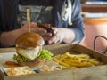 Close up big hamburger with fried egg, french fries and barbeque Royalty Free Stock Photo