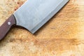 Close up big knife on rought wooden chopping block Royalty Free Stock Photo