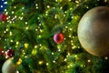 Close up big yellow glitter ball christmas on tree with wire white light background