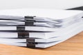 Close-up binder clip pinching stack papers Royalty Free Stock Photo