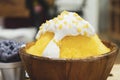 Close-up bingsu or shaved ice dessert topped with coconut fresh cream and served with sticky rice, sweet dessert in Korean style. Royalty Free Stock Photo