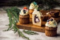 Close up. Biscuit sweet blueberry-lavender muffins, one of them in the cut. Top decorated with a cream hat with berries. Royalty Free Stock Photo