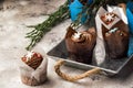 Close up. Biscuit sweet chocolate muffins. Top decorated with a cream hat with Christmas snowflakes of mastic. Gray background Royalty Free Stock Photo