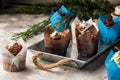 Close up. Biscuit sweet chocolate muffins. Top decorated with a cream hat with Christmas snowflakes of mastic. Gray background. Royalty Free Stock Photo