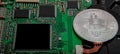 Close-up of bitcoin, computer circuit board with bitcoin processor and microchips. Electronic currency, internet finance rypto cur