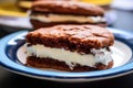 close-up of a bitten vanilla ice cream sandwich on a ceramic plate Royalty Free Stock Photo