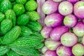 Close-up bitter melon and purple Asian eggplants at local market stand in Little India, Singapore Royalty Free Stock Photo