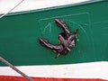 Close-up of black anchor on colorful ship hull Royalty Free Stock Photo